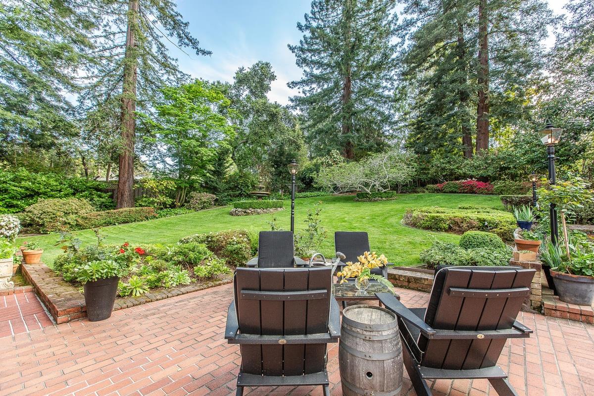 863 Chiltern Road Hillsborough, CA 94010 - Photo 44 of 50 a view of a patio with couches potted plants and a big yard
