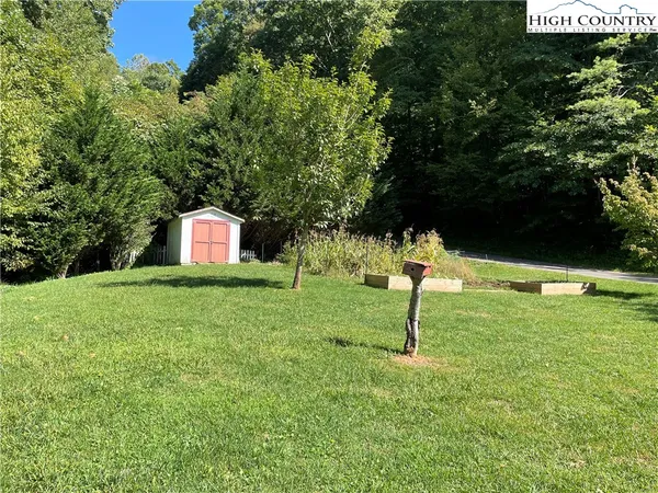 a view of empty room with wooden floor and fireplace