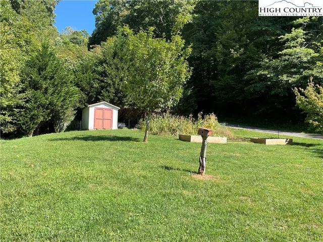 a view of empty room with wooden floor and fireplace