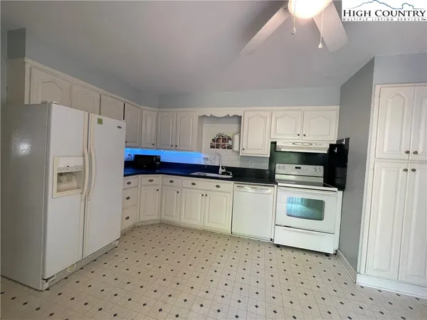 a view of a kitchen with a sink dishwasher and a refrigerator