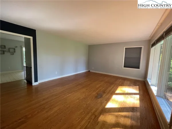 a view of room with window and wooden floor