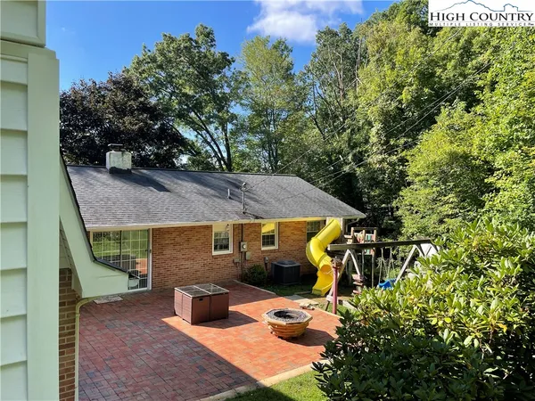 a front view of house with yard and outdoor seating