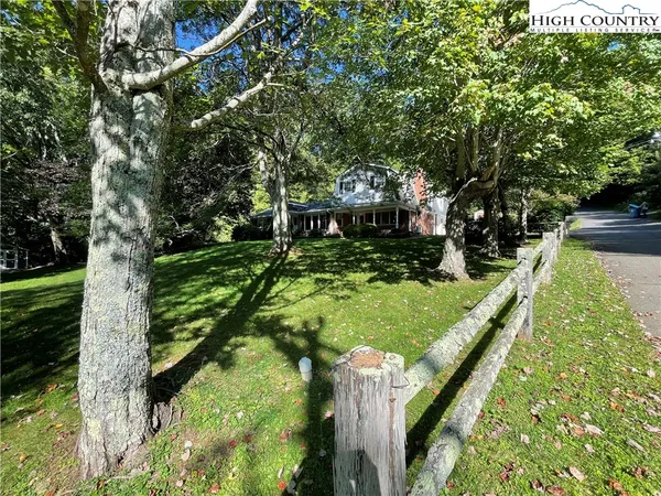 a view of house with yard and green space