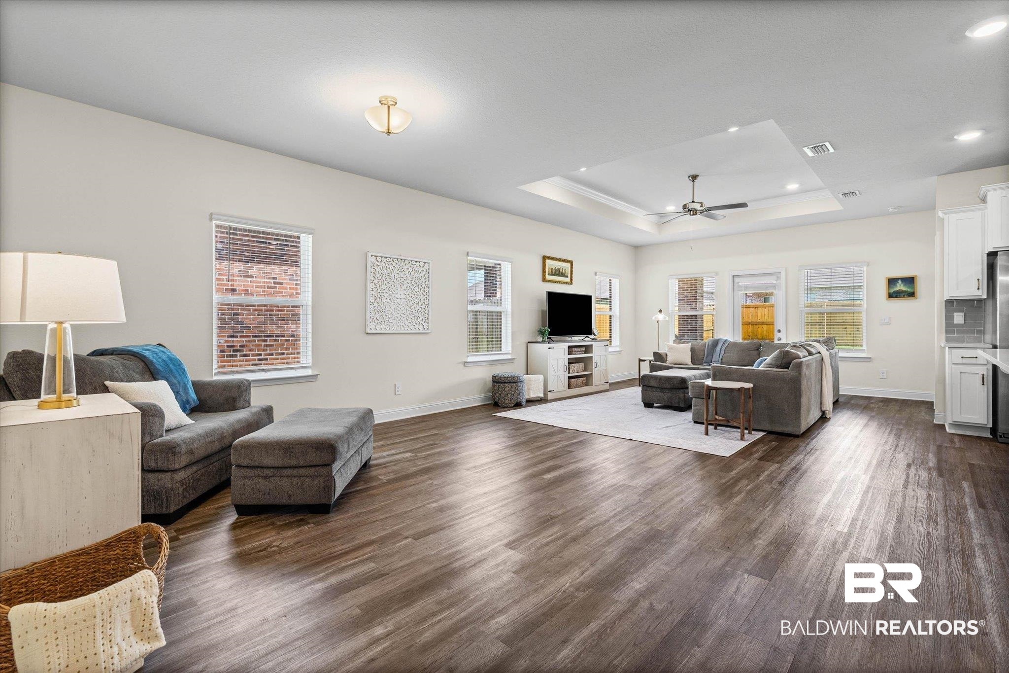 10541 Heirloom Road South Mobile, AL 36608 - Photo 5 of 23 Spacious living area featuring wood-finish flooring, white walls, and multiple windows