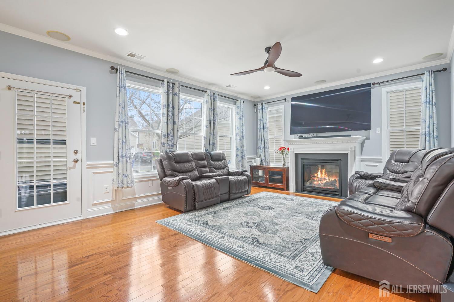 54 Harness Way Chesterfield, NJ 08515 - Photo 13 of 41 a living room with furniture a flat screen tv and a fireplace