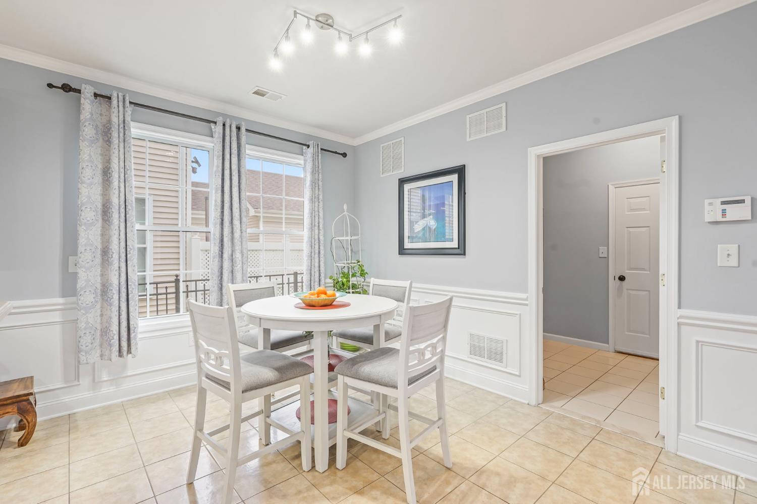 54 Harness Way Chesterfield, NJ 08515 - Photo 16 of 41 a view of a dining room with furniture and a potted plant