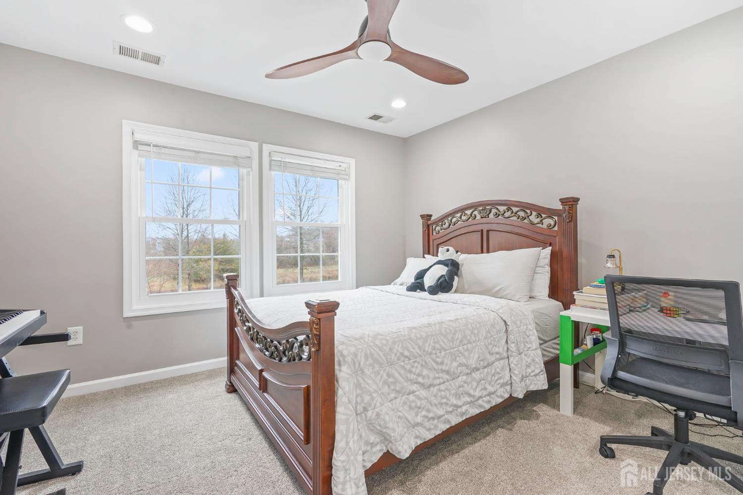 54 Harness Way Chesterfield, NJ 08515 - Photo 27 of 41 a bedroom with a bed a chandelier and a window