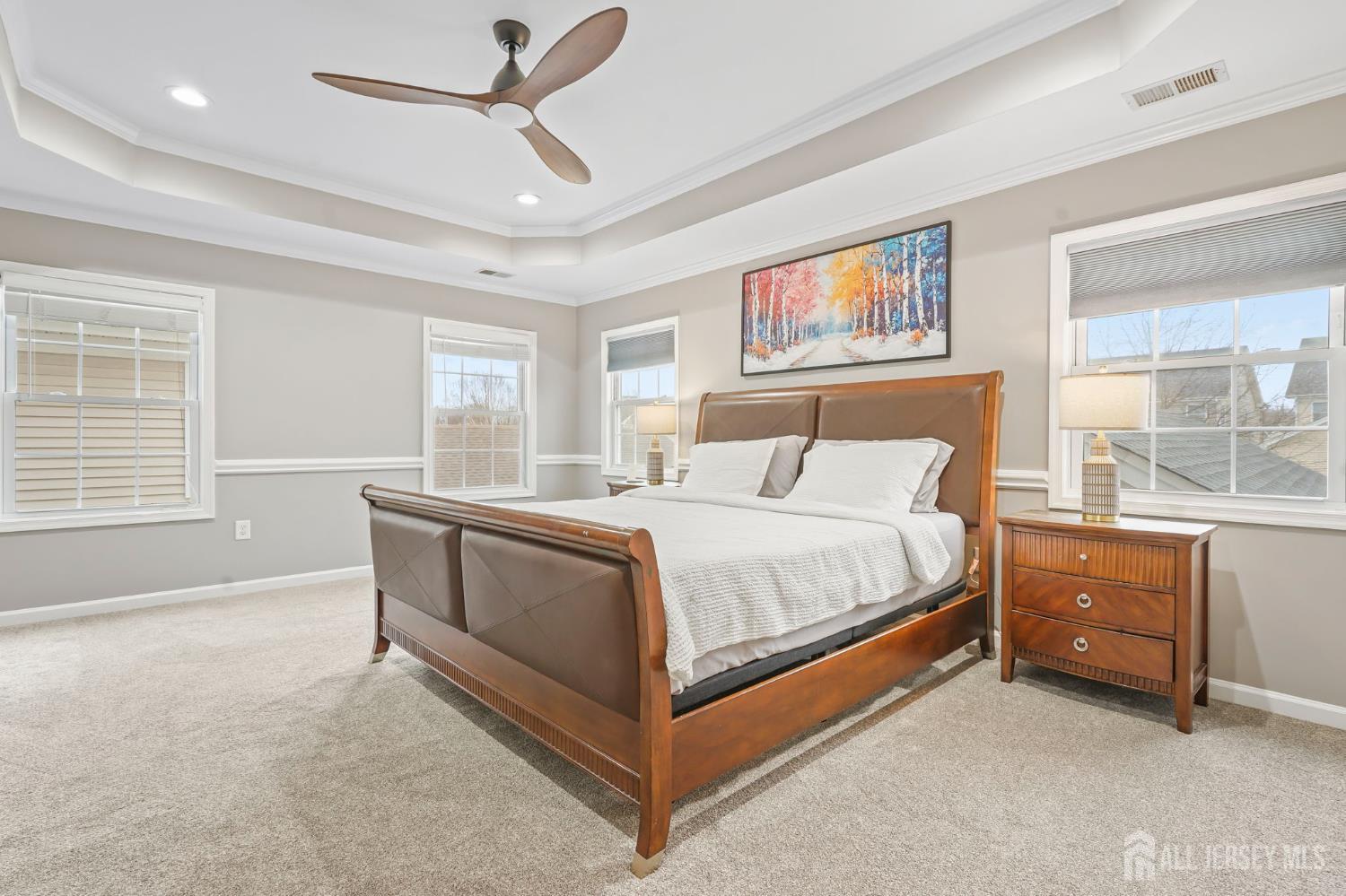 54 Harness Way Chesterfield, NJ 08515 - Photo 31 of 41 a spacious bedroom with a large bed and a chandelier fan