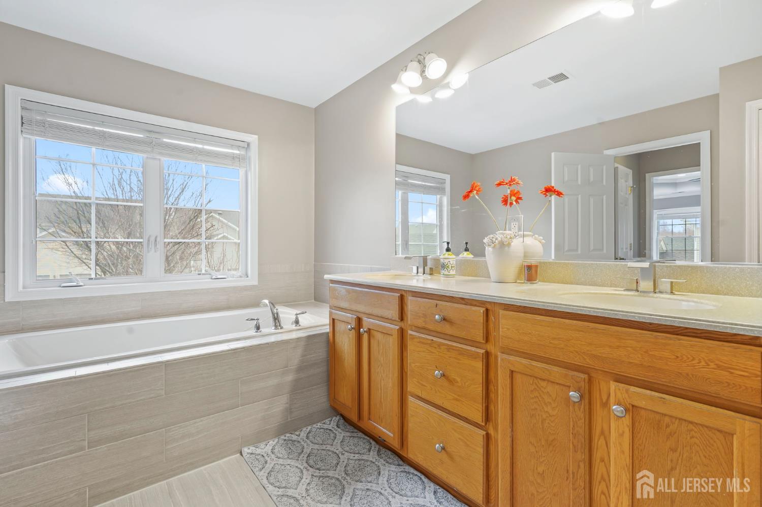 54 Harness Way Chesterfield, NJ 08515 - Photo 33 of 41 a bathroom with a tub sink and mirror