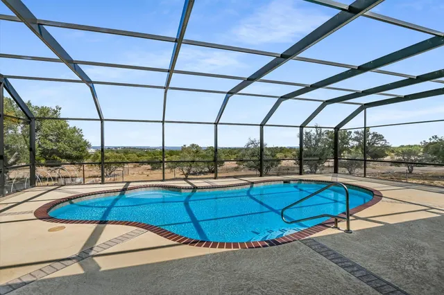a view of outdoor space with green field and trees all around