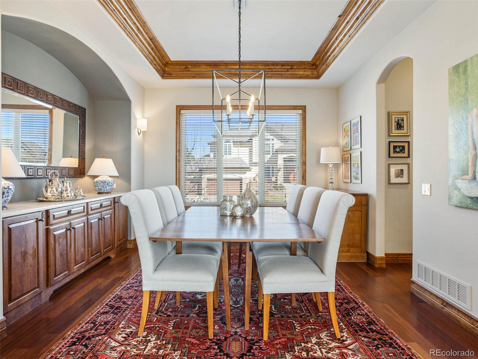1176 Buffalo Ridge Road Castle Pines, CO 80108 - Photo 14 of 37 a view of a dining room with furniture window and wooden floor