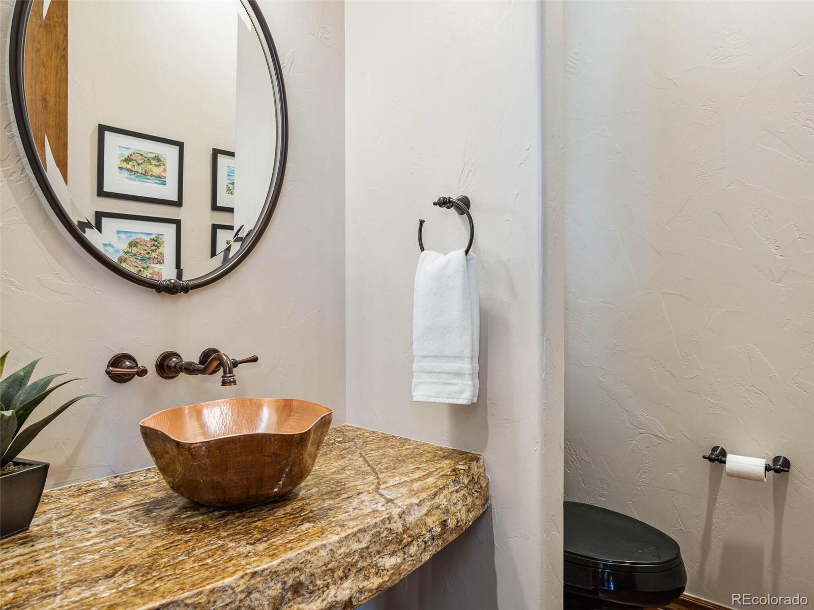 1176 Buffalo Ridge Road Castle Pines, CO 80108 - Photo 16 of 37 a room with a sink and mirror
