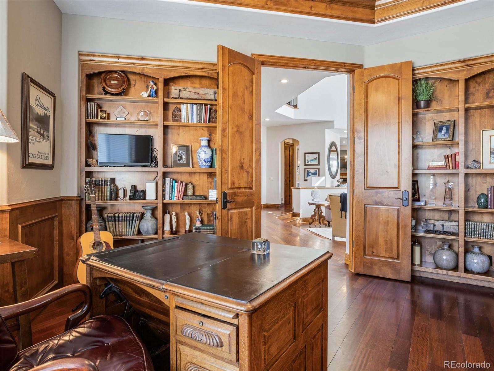1176 Buffalo Ridge Road Castle Pines, CO 80108 - Photo 17 of 37 a dining hall with stainless steel appliances granite countertop a stove and a dining table with wooden floor