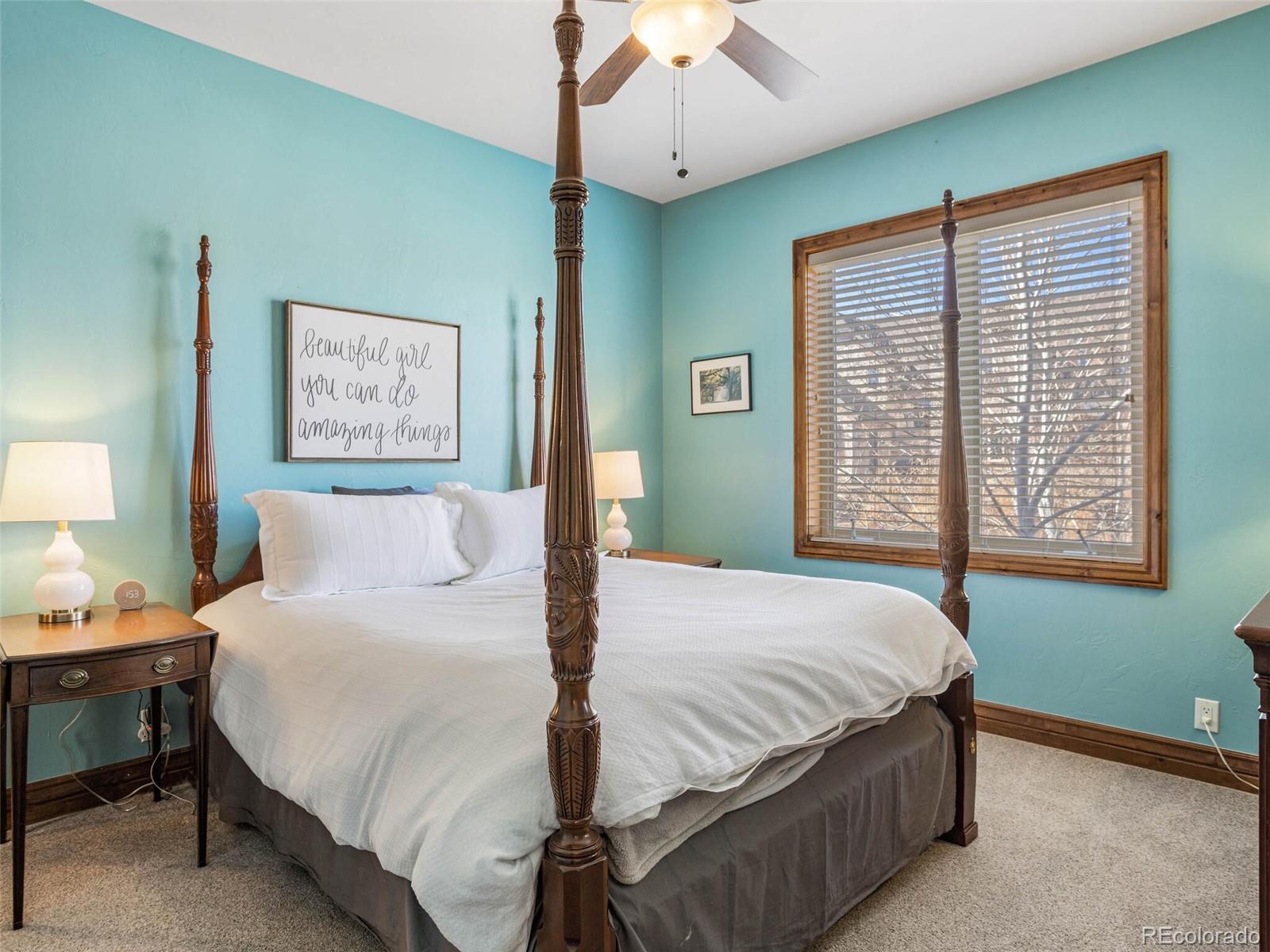 1176 Buffalo Ridge Road Castle Pines, CO 80108 - Photo 24 of 37 a bedroom with a large bed and a window