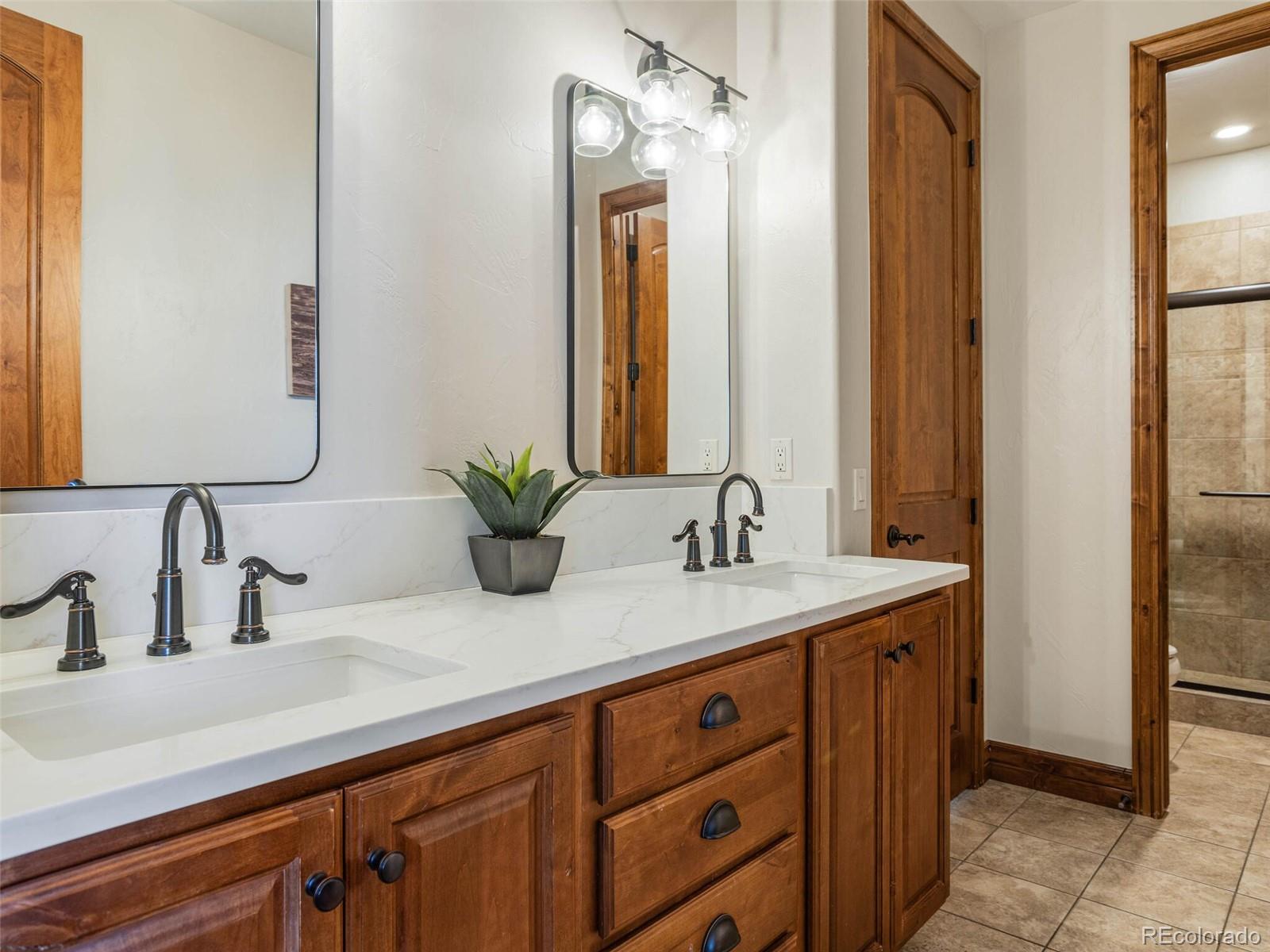 1176 Buffalo Ridge Road Castle Pines, CO 80108 - Photo 25 of 37 a bathroom with a sink and a mirror