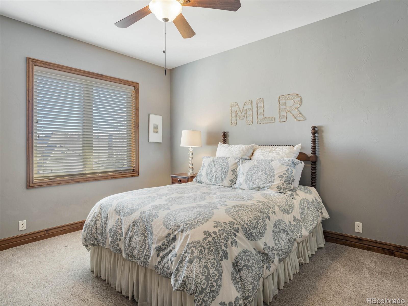1176 Buffalo Ridge Road Castle Pines, CO 80108 - Photo 26 of 37 a bedroom with a bed and a window