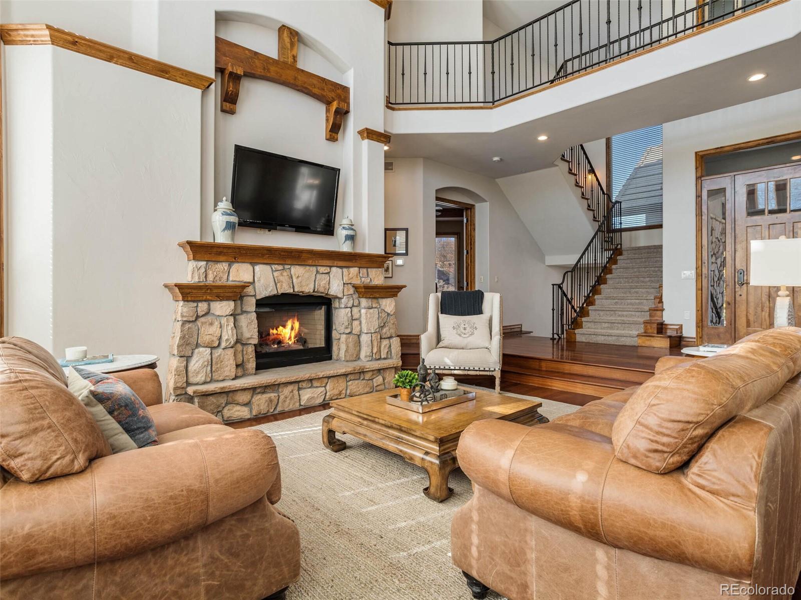 1176 Buffalo Ridge Road Castle Pines, CO 80108 - Photo 5 of 37 a living room with furniture and a fireplace