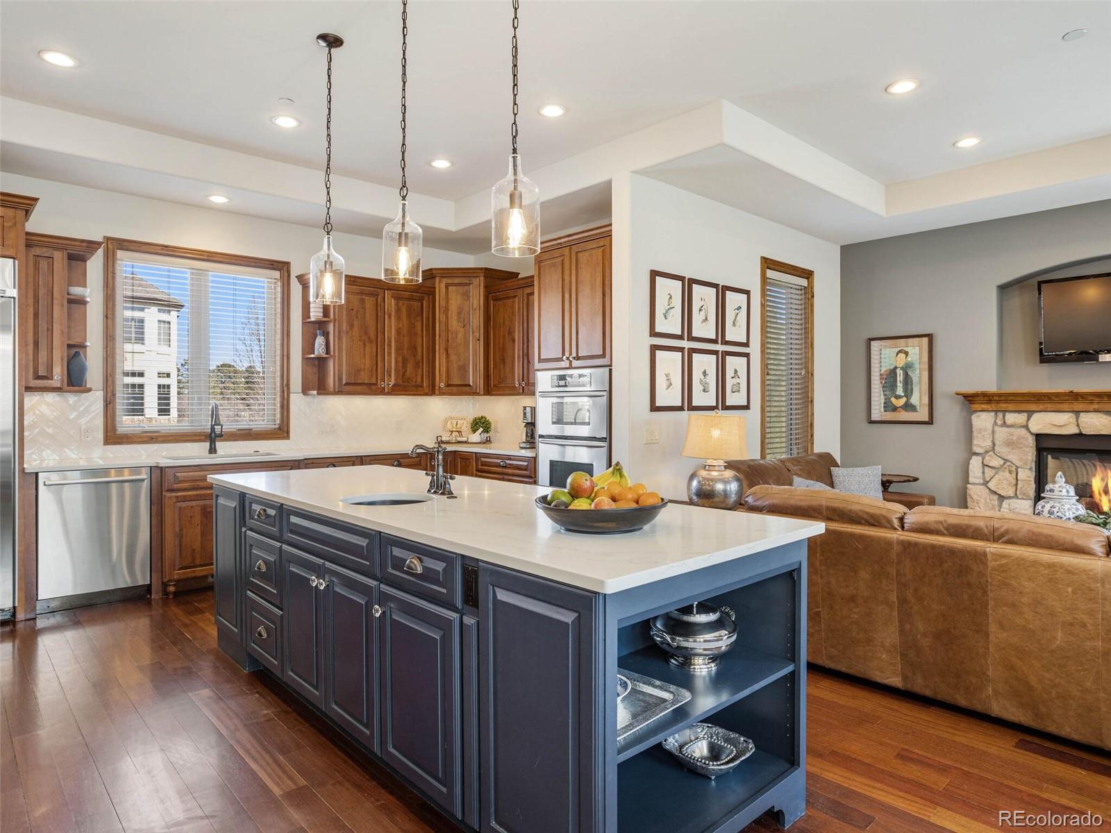 1176 Buffalo Ridge Road Castle Pines, CO 80108 - Photo 6 of 37 a kitchen with sink stove and cabinets