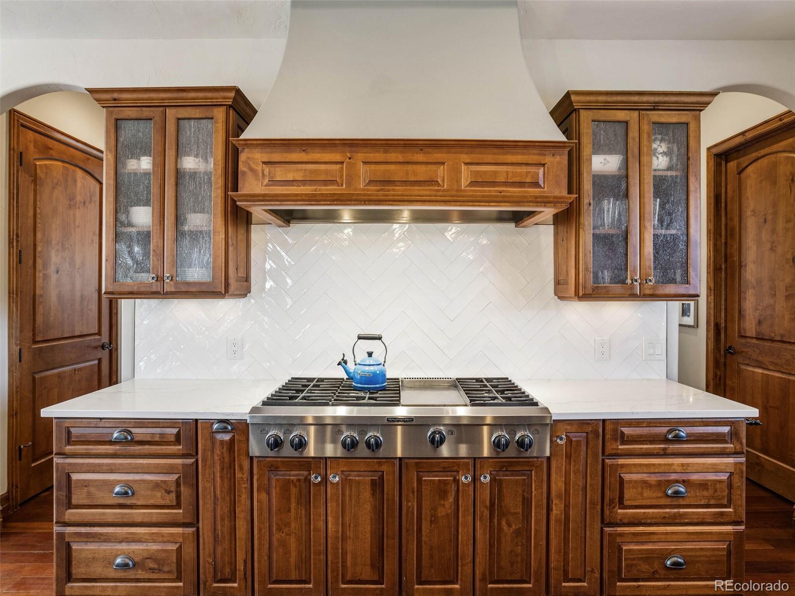 1176 Buffalo Ridge Road Castle Pines, CO 80108 - Photo 8 of 37 a kitchen with a stove and a sink