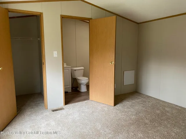 a white toilet sitting next to a shower