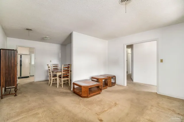 a view of an empty room with a kitchen