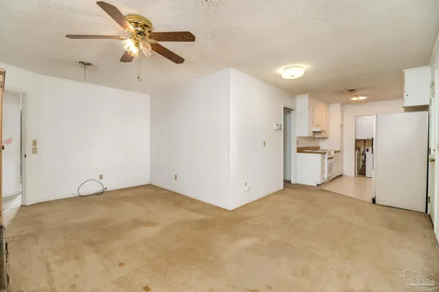 a kitchen that has a refrigerator and a sink
