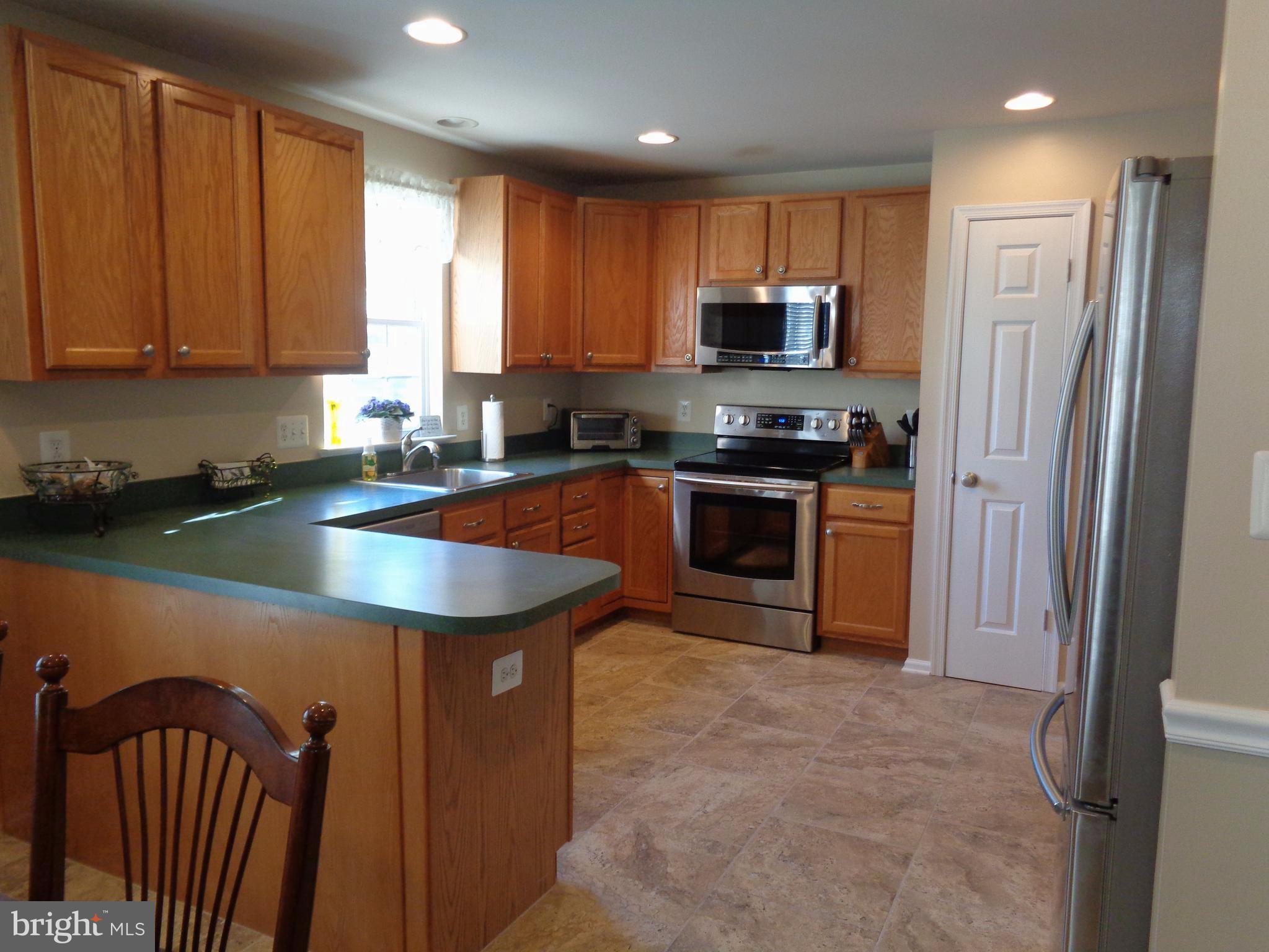 New tile flooring, SS appliances, recess. lighting