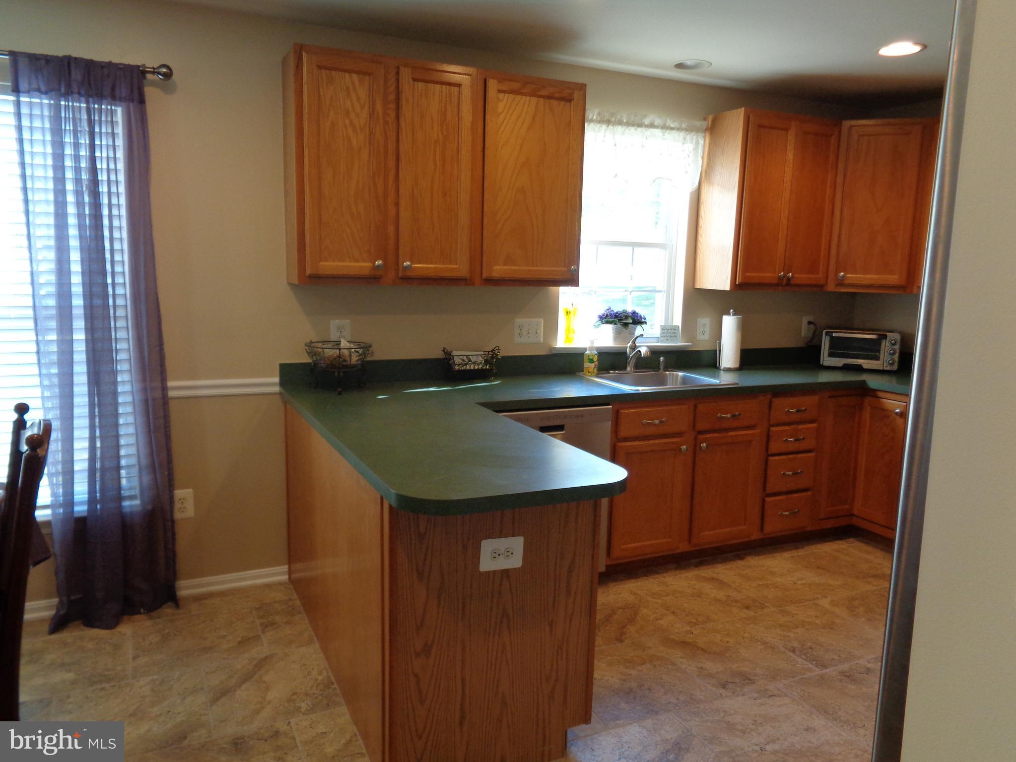 Sunny kitchen with ample cabinetry