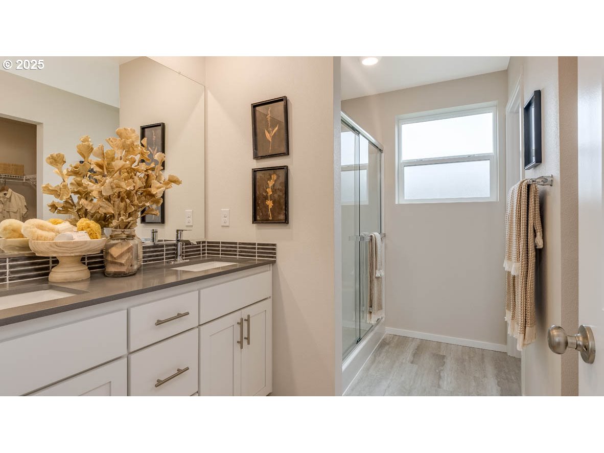 9266 Southeast Middleton Street Happy Valley, OR 97086 - Photo 11 of 14 a bathroom with a sink a mirror and a shower