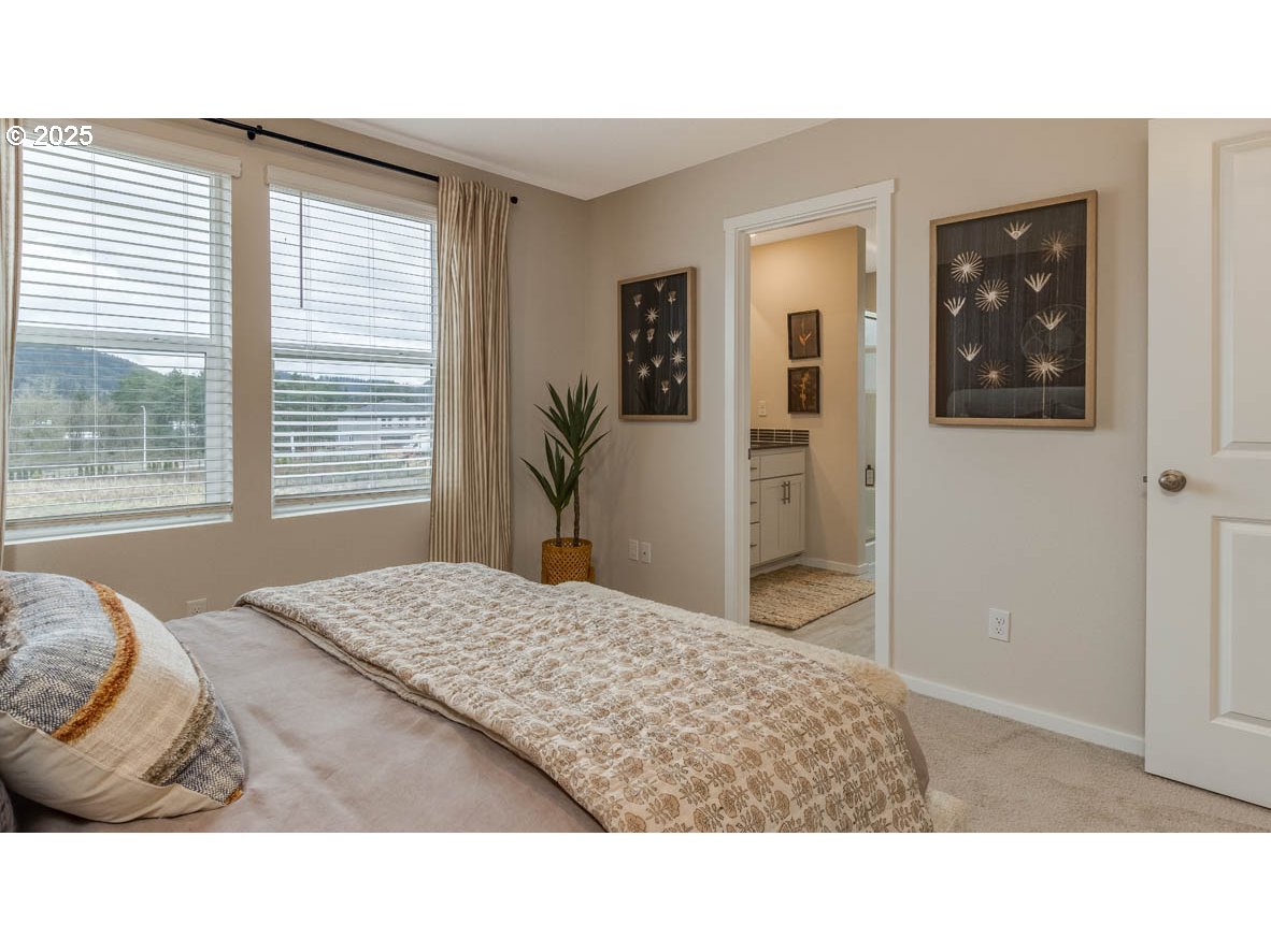 9266 Southeast Middleton Street Happy Valley, OR 97086 - Photo 10 of 14 a living room with a bed furniture and next to a window