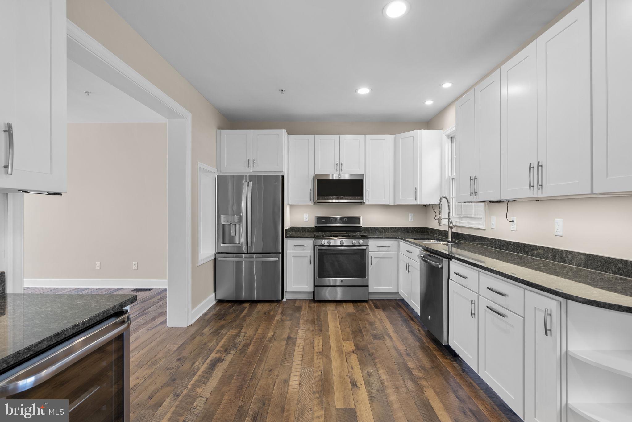 1304 Hill Born Drive Hanover, MD 21076 - Photo 11 of 47 a kitchen with granite countertop white cabinets and stainless steel appliances