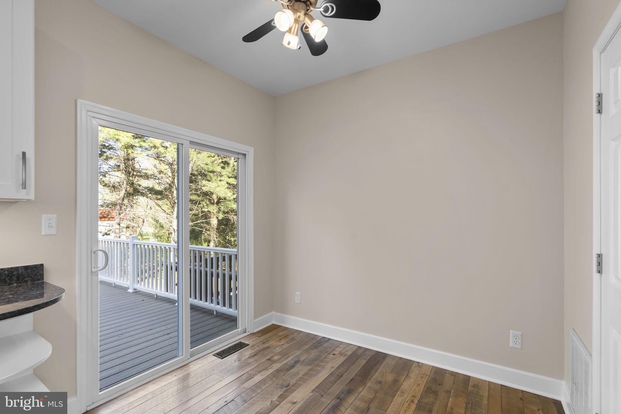 1304 Hill Born Drive Hanover, MD 21076 - Photo 13 of 47 a view of a livingroom with wooden floor and a ceiling fan