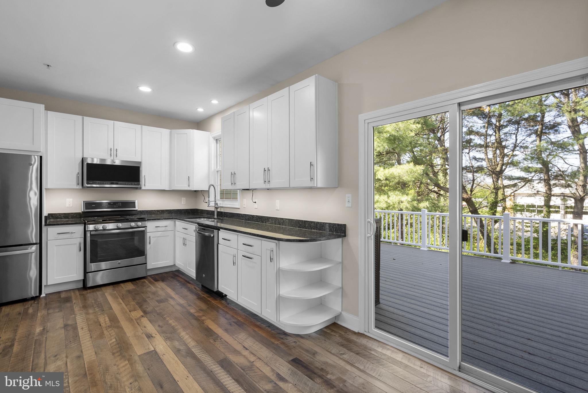 1304 Hill Born Drive Hanover, MD 21076 - Photo 14 of 47 a kitchen with granite countertop white cabinets and stainless steel appliances