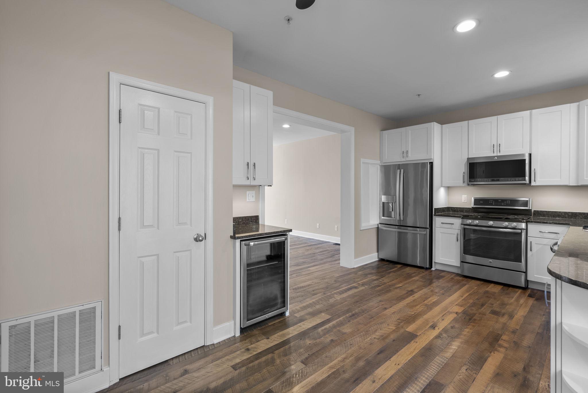 1304 Hill Born Drive Hanover, MD 21076 - Photo 15 of 47 a kitchen with granite countertop a refrigerator and a stove top oven