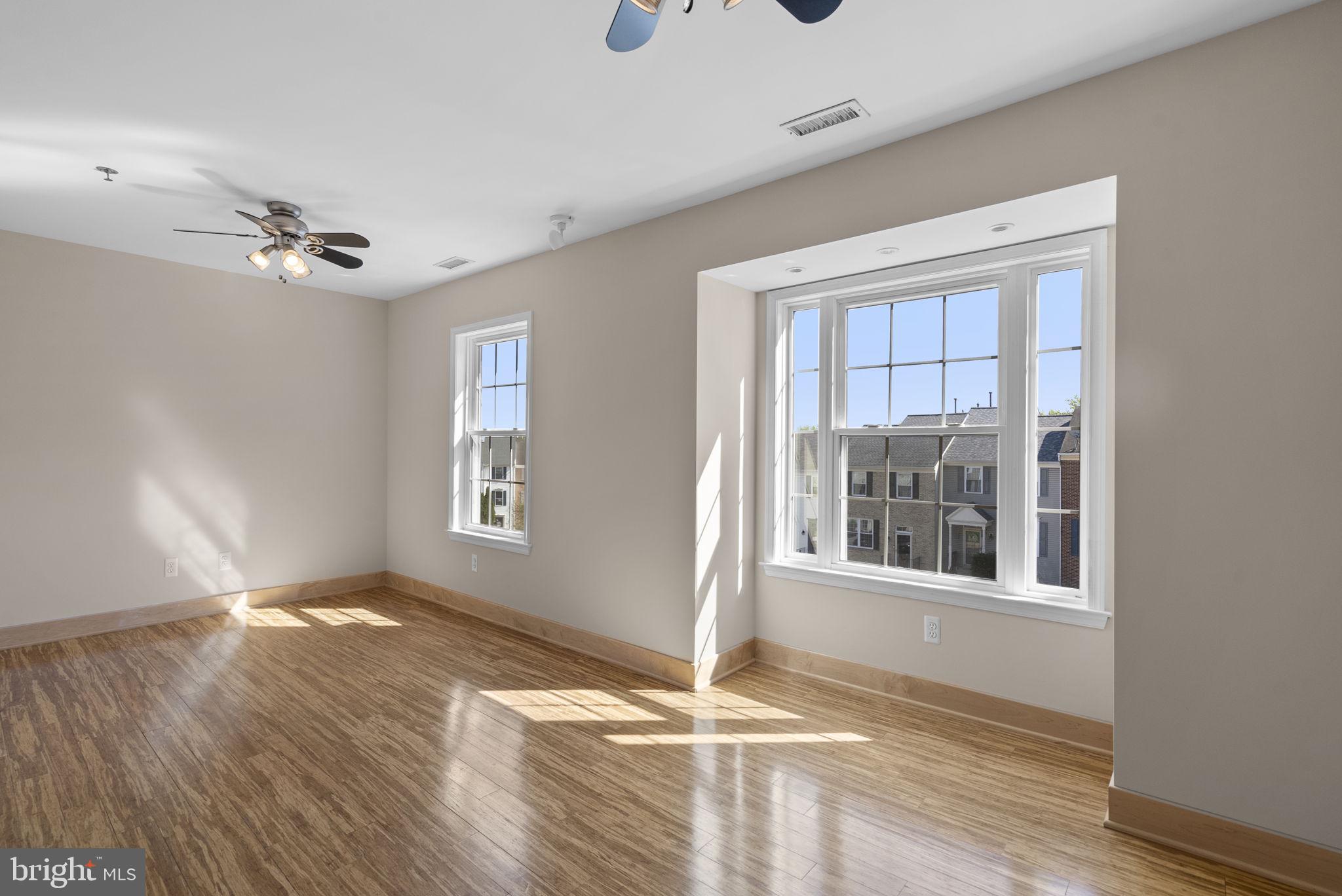 1304 Hill Born Drive Hanover, MD 21076 - Photo 24 of 47 a view of an empty room with a window and wooden floor