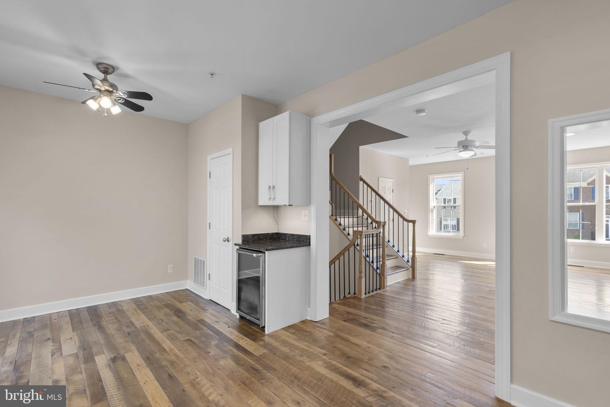 1304 Hill Born Drive Hanover, MD 21076 - Photo 8 of 47 a view of main area with wooden floor and staircase