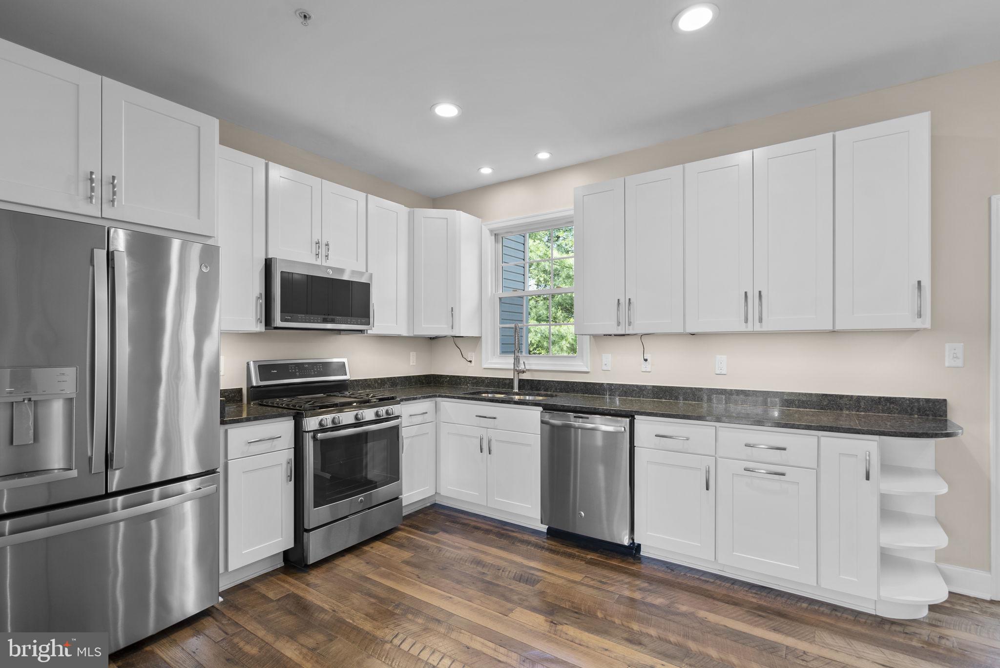 1304 Hill Born Drive Hanover, MD 21076 - Photo 10 of 47 a kitchen with white cabinets stainless steel appliances and sink