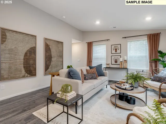 a living room with furniture potted plant and a window