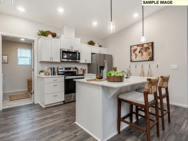 a kitchen with a sink a microwave and refrigerator