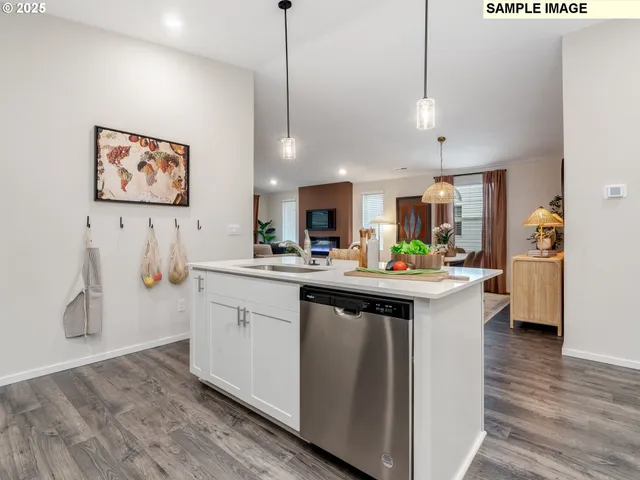 a kitchen with stainless steel appliances granite countertop a sink a stove and a wooden floors