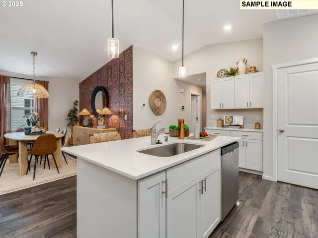 a kitchen with a sink stools a counter space and cabinets