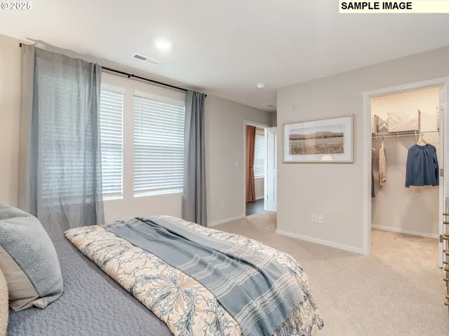 a bedroom with a large bed and a window