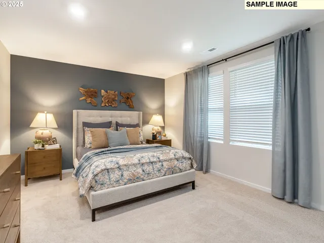 a bedroom with a bed and a painting on the wall