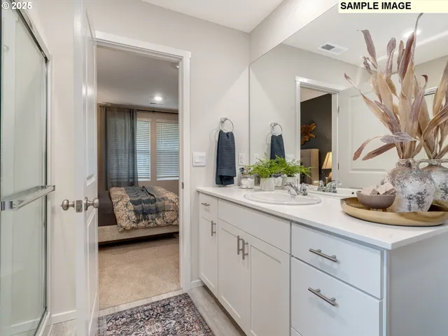 a en suite bathroom with double sink and a mirror