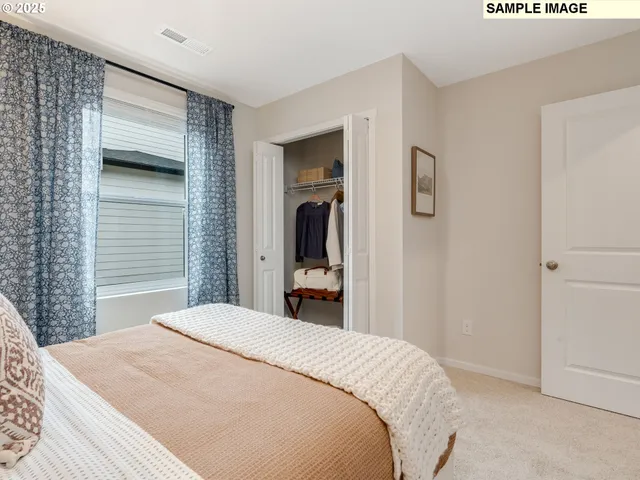 a bedroom with a bed and a large mirror