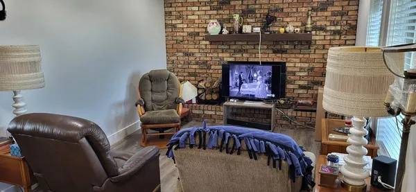 a view of a livingroom with furniture and a fireplace