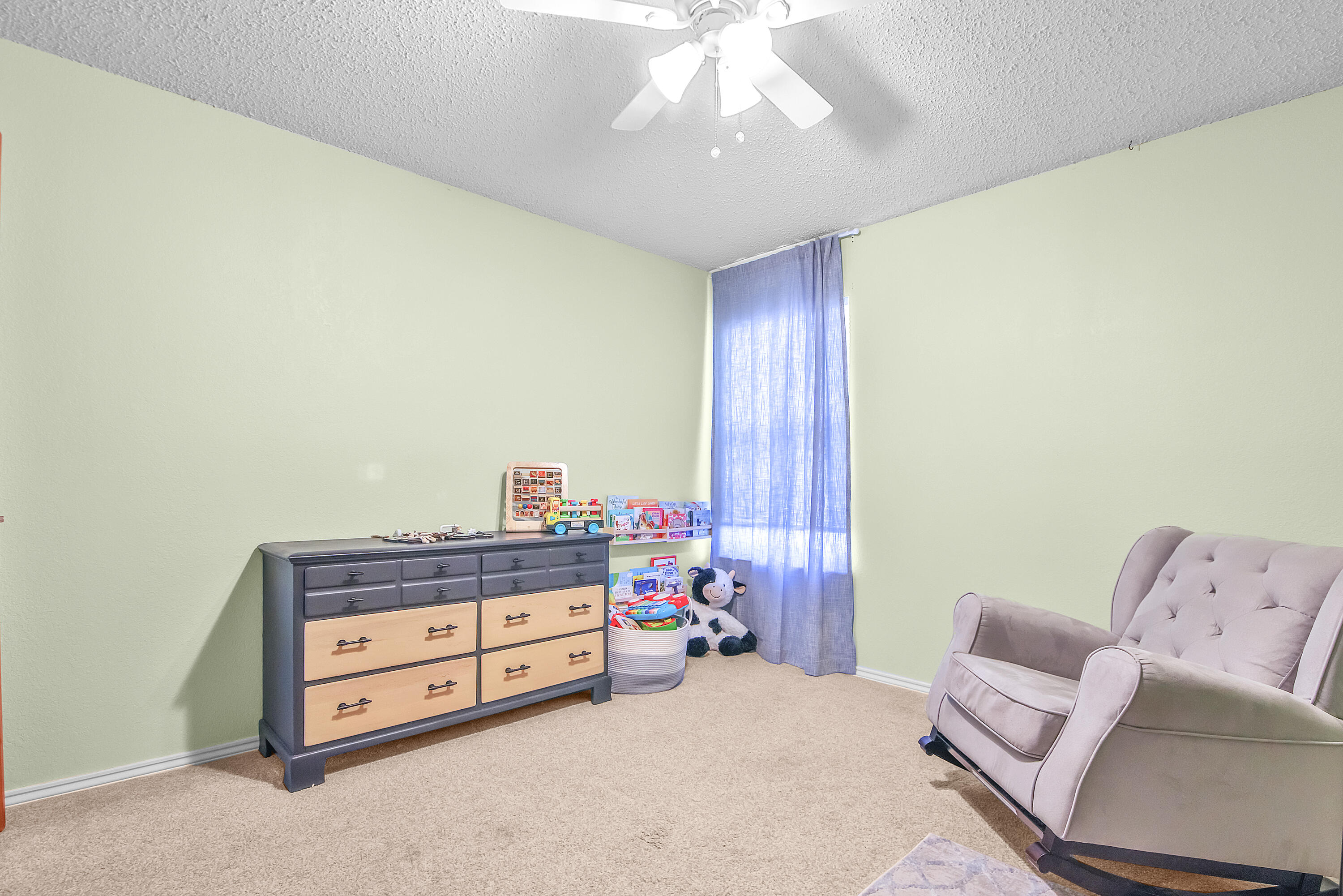 4805 73rd Street Lubbock, TX 79424 - Photo 22 of 26 a living room with furniture and a chandelier