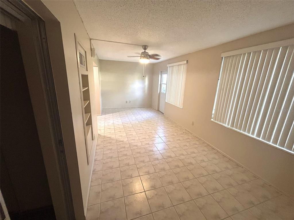 2402 Ecuadorian Way, Unit 18 Clearwater, FL 33763 - Photo 15 of 55 a view of a hallway with a windows and a chandelier