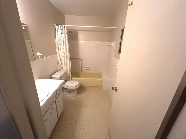 a bathroom with a sink and mirror with toilet