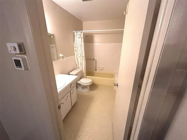 a bathroom with a sink a toilet a mirror and vanity